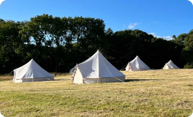 Outside view of glamping tents at nightfall